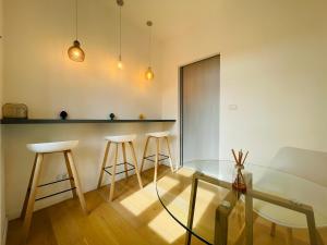 a living room with a glass table and stools at Dimora del Mercante in Catania