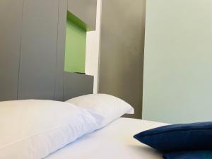 a bedroom with a bed with a white pillow at Dimora del Mercante in Catania