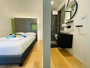 a bedroom with a bed and a bathroom with a sink at Dimora del Mercante in Catania
