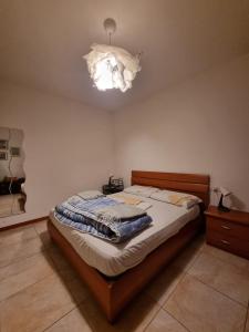 a bedroom with a bed and a chandelier at Sea House Rimini Fiera in Rimini