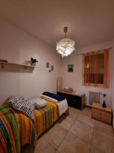 a bedroom with a bed and a desk and a lamp at Sea House Rimini Fiera in Rimini