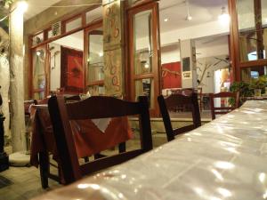 a dining room with a long table and chairs at Megim Hotel in Palaiochora