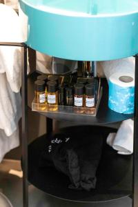 a shelf with bottles of essential oils on it at The Market Urban Hotel in Florence
