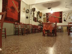 a dining room with a table and chairs at Megim Hotel in Palaiochora