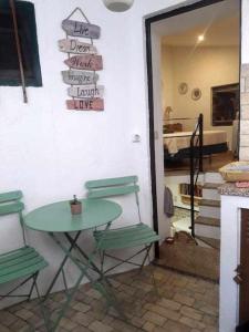 a table and two chairs in a room with a table and a door at A Toca do Cuco na Vila da Sertã in Sertã