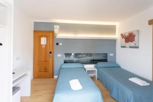 Postel nebo postele na pokoji v ubytování Hotel Raxa