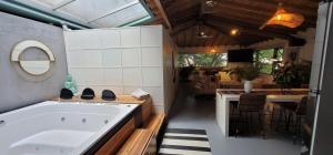a bathroom with a tub and a kitchen with a table at Vintage House With Jacuzzi In Manila in Medellín +106 photos