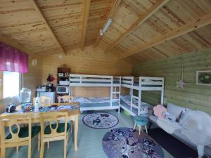Pokój z łóżkiem piętrowym, stołem i jadalnią w obiekcie Satukurki-vierasmaja - Simple and Cute Cabin w mieście Sastamala