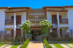 a building with a sign on the front of it at Encantos de Itaperapuã in Porto Seguro