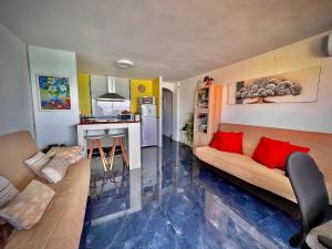 a living room with a couch and a kitchen at Blue Salou in Salou