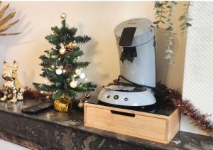 a coffee maker and a christmas tree on a counter at "Le Studio" Les Halles - Tout Confort - Parking - Arrivée Autonome in Tours