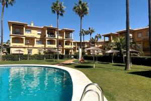 een resort met een zwembad voor een gebouw bij Novo Sancti Petri, La Barrosa, 2 Beds Room Apartamento by Chiclana Dreams in Chiclana de la Frontera