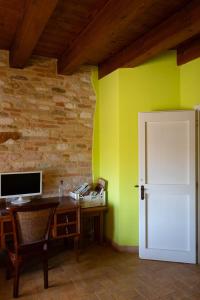 a room with a desk and a white door at Agriturismo Dai Mori in Isola del Piano