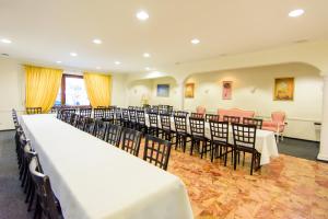 a room with rows of tables and chairs in it at Hotel Bohn in Metzingen