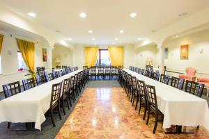 a row of tables and chairs in a room at Hotel Bohn in Metzingen