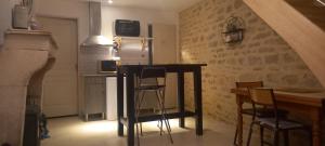 eine Küche mit einem Tisch und Stühlen im Zimmer in der Unterkunft Le cottage du village in Seigny