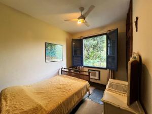 Ένα ή περισσότερα κρεβάτια σε δωμάτιο στο Recanto Lírio da Paz +42 φωτογραφίες