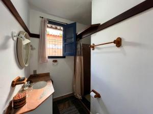 a small bathroom with a sink and a window at Recanto Lírio da Paz in Guapimirim +27 photos