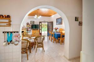 a kitchen and dining room with an archway in a house at Olive Tree Villa in Ieromónachos