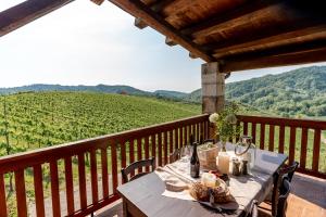 a table on a balcony with a view of a vineyard at Duca Di Dolle in Rolle