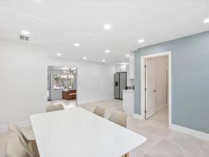 a white dining room with a white table and chairs at New Villa, Pool, Near Hard Rock 4BR3 in Davie