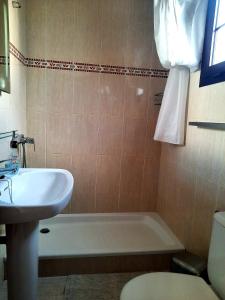 a bathroom with a tub and a sink and a toilet at Sun beach Caleta 24 in Caleta De Fuste