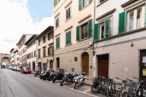 a row of motorcycles parked on the side of a street at Modern, Bright near Boboli Gardens & Santo Spirito - HomeUnity in Florence