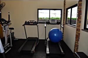 a gym with exercise equipment and a blue ball in it at FORTALEZA FLAT apt 203 COM VARANDA in Fortaleza