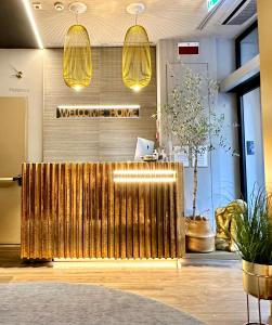 a lobby with a gold bench in front of a store at The Market Urban Hotel in Florence