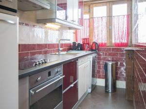 a kitchen with a sink and a stove at Appartement Tignes, 3 pièces, 7 personnes - FR-1-449-36 in Tignes