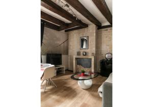 a living room with a table and a fireplace at "L'Appart" Vieux Tours - Charme - Place Plumereau - Arrivée Autonome in Tours