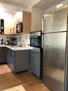 a kitchen with a stainless steel refrigerator and a sink at Stylish apartments in the heart of the city! in Tashkent