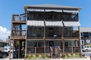 a large apartment building with balconies on a street at Beach Walk Hotel in Ocean City