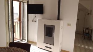 a living room with a fireplace with a flat screen tv at Majella National Park La Casa Di Nonna Maria in Caramanico Terme