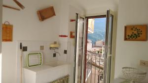 a white room with a balcony with a window at Majella National Park La Casa Di Nonna Maria in Caramanico Terme