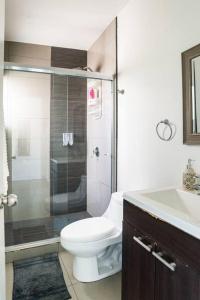 a bathroom with a toilet and a shower and a sink at #CasaMare - Privada a una cuadra del mar con AC in Ensenada