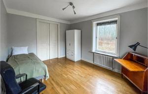 an empty bedroom with a bed and a piano at 4 Bedroom Lovely Home In Södra Sandby in Södra Sandby