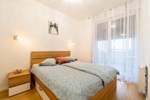 a bedroom with a bed and a large window at Flexible SelfCheckIns 38 - Zagreb - Garage - Loggia - New - Luxury - in Zagreb