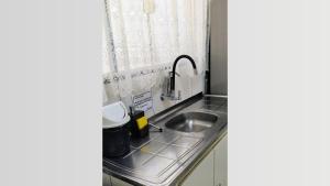 a small kitchen with a sink and a window at Casa Executiva Orla Morena in Campo Grande