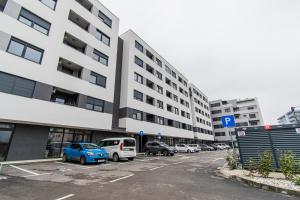 a parking lot with cars parked in front of a building at Flexible SelfCheckIns 38 - Zagreb - Garage - Loggia - New - Luxury - in Zagreb