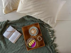 a tray of food and a cup of coffee on a bed at La Siesta bungalows ONLY ADULTS in Gili Air