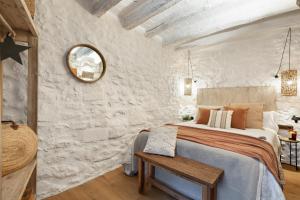 a bedroom with a large bed and a mirror at El Pajar de Jafre , Costa Brava Empordà 