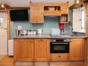 a kitchen with wooden cabinets and a stove top oven at Arts and Crafts in York