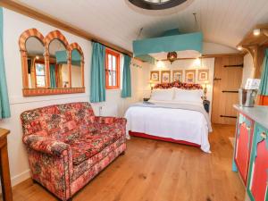 a bedroom with a bed and a couch at The Storyteller in York