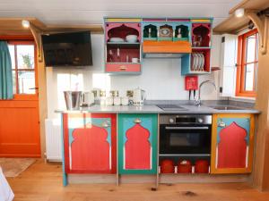 a kitchen with a play kitchen with colorful cabinets at The Storyteller in York