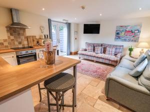 a kitchen and living room with a table and a couch at Hornington Lodge in York