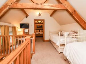 a attic bedroom with two beds and a balcony at Hornington Lodge in York
