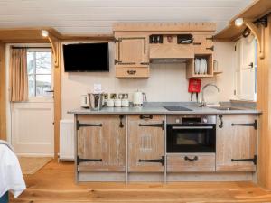 a kitchen with wooden cabinets and a counter top at The White Princess in York