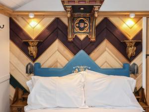 a bed in a room with a wooden wall at The White Princess in York