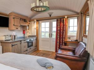 a kitchen with a bed and a chair in a room at The White Princess in York